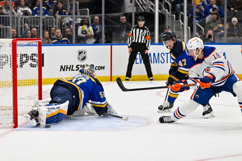 Feb 15, 2024; St. Louis, Missouri, USA;  St. Louis Blues goaltender Jordan Binnington (50) makes a save against Edmonton Oilers left wing Zach Hyman (18) during the first period at Enterprise Center. Mandatory Credit: Jeff Curry-USA TODAY Sports