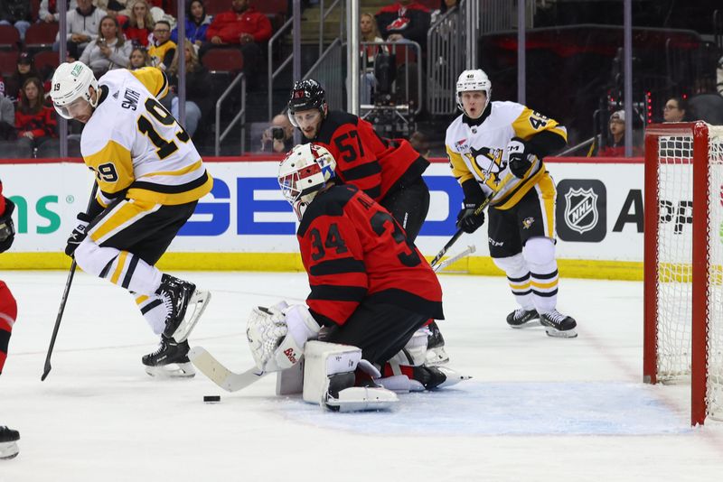 Mar 19, 2024; Newark, New Jersey, USA; New Jersey Devils goaltender Jake Allen (34) makes a save against the Pittsburgh Penguins during the first period at Prudential Center. Mandatory Credit: Ed Mulholland-USA TODAY Sports