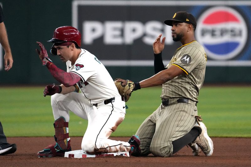 Aug 4, 2025; Phoenix, Arizona, USA; Arizona Diamondbacks outfielder Corbin Carroll (7) reacts after hitting a double in front of San Diego Padres shortstop Xander Bogaerts (2) in the first inning at Chase Field. Mandatory Credit: Rick Scuteri-Imagn Images