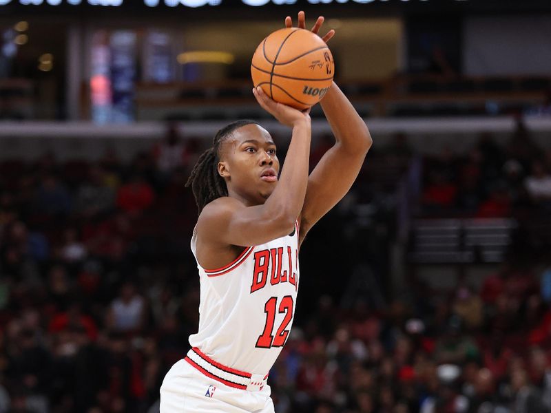 CHICAGO, ILLINOIS - DECEMBER 02: Ayo Dosunmu #12 of the Chicago Bulls shoots a three pointer against the New Orleans Pelicans during the first half at the United Center on December 02, 2023 in Chicago, Illinois. NOTE TO USER: User expressly acknowledges and agrees that, by downloading and or using this photograph, User is consenting to the terms and conditions of the Getty Images License Agreement.  (Photo by Michael Reaves/Getty Images)