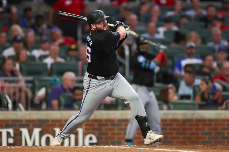 Aug 3, 2024; Atlanta, Georgia, USA; Miami Marlins first baseman Jake Burger (36) hits a RBI single against the Atlanta Braves in the fifth inning at Truist Park. Mandatory Credit: Brett Davis-USA TODAY Sports