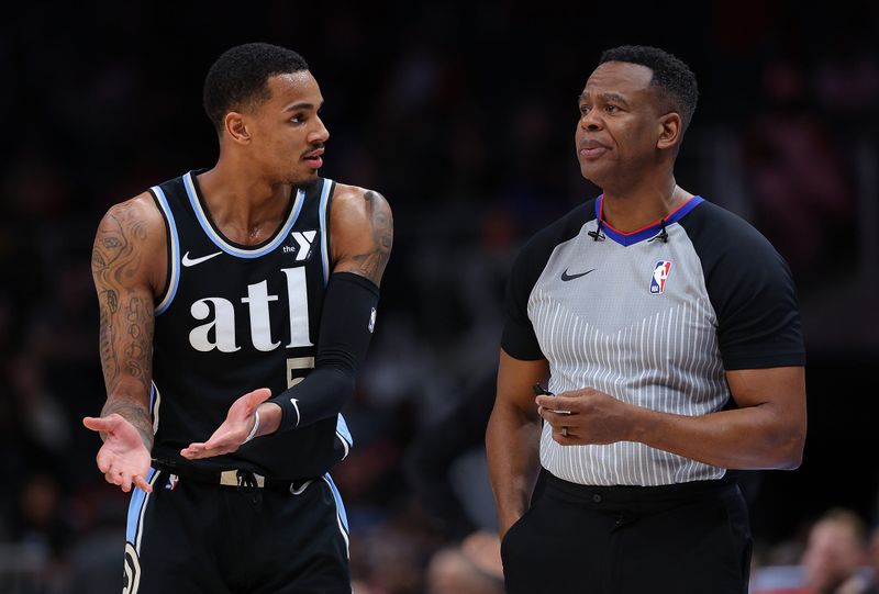 ATLANTA, GEORGIA - FEBRUARY 12:  Dejounte Murray #5 of the Atlanta Hawks reacts to official Sean Wright #4 after being charged with a foul against Coby White #0 of the Chicago Bulls during the fourth quarter at State Farm Arena on February 12, 2024 in Atlanta, Georgia.  NOTE TO USER: User expressly acknowledges and agrees that, by downloading and/or using this photograph, user is consenting to the terms and conditions of the Getty Images License Agreement.  (Photo by Kevin C. Cox/Getty Images)