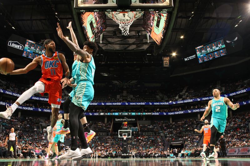 CHARLOTTE, NC - APRIL 7: Isaiah Joe #11 of the Oklahoma City Thunder looks to pass the ball during the game against the Charlotte Hornets on April 7, 2024 at Spectrum Center in Charlotte, North Carolina. NOTE TO USER: User expressly acknowledges and agrees that, by downloading and or using this photograph, User is consenting to the terms and conditions of the Getty Images License Agreement. Mandatory Copyright Notice: Copyright 2024 NBAE (Photo by Kent Smith/NBAE via Getty Images)