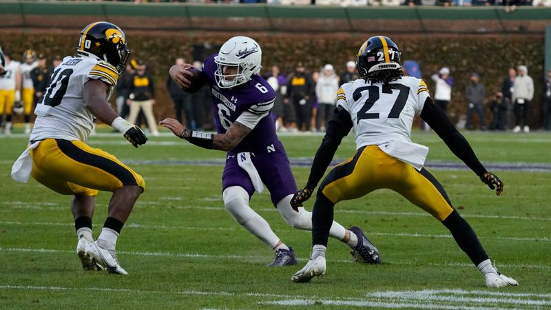 Nov 4, 2023; Chicago, Illinois, USA; Northwestern Wildcats quarterback Brendan Sullivan (6) runs against the Iowa Hawkeyes during the second half at Wrigley Field. Mandatory Credit: David Banks-USA TODAY Sports