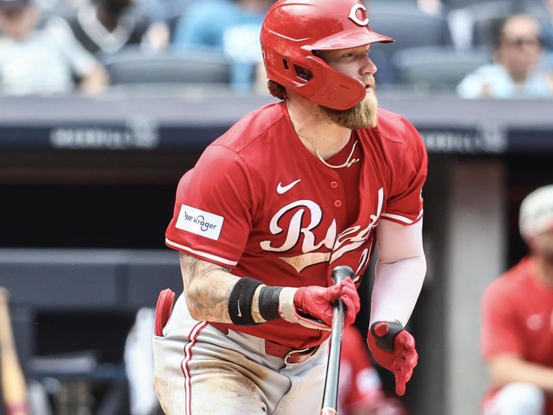 Jul 4, 2024; Bronx, New York, USA; Cincinnati Reds right fielder Jake Fraley (27) hits a three run triple in the seventh inning against the New York Yankees at Yankee Stadium. Mandatory Credit: Wendell Cruz-USA TODAY Sports