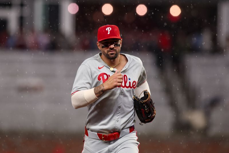 Apr 10, 2025; Atlanta, Georgia, USA; Philadelphia Phillies right fielder Nick Castellanos (8) runs off the field in the rain against the Atlanta Braves in the sixth inning at Truist Park. Mandatory Credit: Brett Davis-Imagn Images