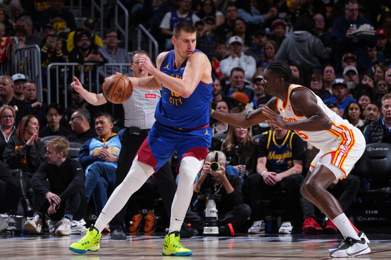 DENVER, CO - APRIL 6: Nikola Jokic #15 of the Denver Nuggets dribbles the ball during the game against the Atlanta Hawks on April 6, 2024 at the Ball Arena in Denver, Colorado. NOTE TO USER: User expressly acknowledges and agrees that, by downloading and/or using this Photograph, user is consenting to the terms and conditions of the Getty Images License Agreement. Mandatory Copyright Notice: Copyright 2024 NBAE (Photo by Garrett Ellwood/NBAE via Getty Images)