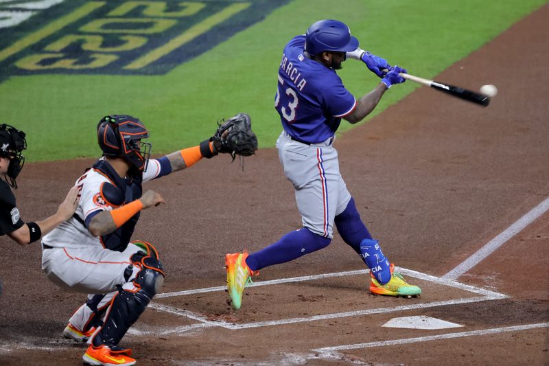 Oct 23, 2023; Houston, Texas, USA; Texas Rangers right fielder Adolis Garcia (53) hits a RBI single during the first inning of game seven in the ALCS against the Houston Astros for the 2023 MLB playoffs at Minute Maid Park.  Mandatory Credit: Erik Williams-USA TODAY Sports