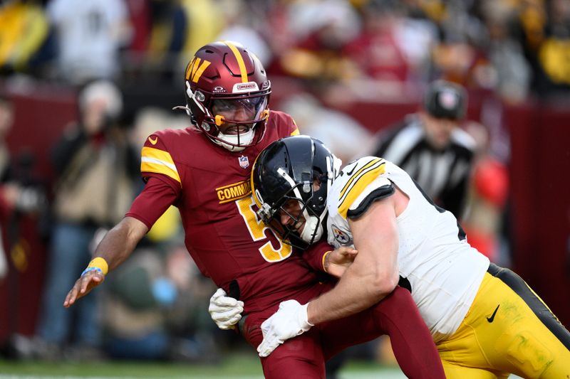 Washington Commanders quarterback Jayden Daniels is pressured by Pittsburgh Steelers linebacker T.J. Watt (90) during the second half of an NFL football game, Sunday, Nov. 10, 2024, in Landover, Md. (AP Photo/Nick Wass)