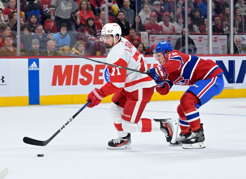 Apr 16, 2024; Montreal, Quebec, CAN; Detroit Red Wings forward Dylan Larkin (71) plays the puck and Montreal Canadiens forward Christian Dvorak (28) defends during the first period at the Bell Centre. Mandatory Credit: Eric Bolte-USA TODAY Sports