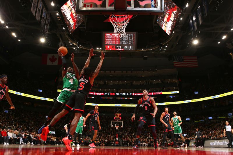 TORONTO, CANADA - JANUARY 15:  Jrue Holiday #4 of the Boston Celtics drives to the basket during the game against the Toronto Raptors on January 15, 2024 at the Scotiabank Arena in Toronto, Ontario, Canada.  NOTE TO USER: User expressly acknowledges and agrees that, by downloading and or using this Photograph, user is consenting to the terms and conditions of the Getty Images License Agreement.  Mandatory Copyright Notice: Copyright 2024 NBAE (Photo by Vaughn Ridley/NBAE via Getty Images)