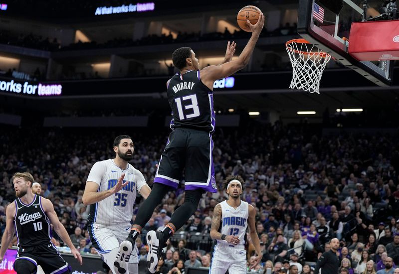 SACRAMENTO, CALIFORNIA - JANUARY 03: Keegan Murray #13 of the Sacramento Kings goes in for a layup against the Orlando Magic during the first half of an NBA basketball game at Golden 1 Center on January 03, 2024 in Sacramento, California. NOTE TO USER: User expressly acknowledges and agrees that, by downloading and or using this photograph, User is consenting to the terms and conditions of the Getty Images License Agreement. (Photo by Thearon W. Henderson/Getty Images)