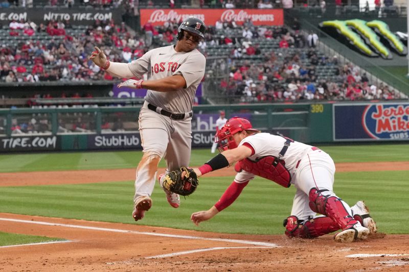 May 24, 2023; Anaheim, California, USA; Boston Red Sox third baseman Rafael Devers (11) is tagged out at home plate by Los Angeles Angels catcher Chad Wallach (35) in the second inning at Angel Stadium. Mandatory Credit: Kirby Lee-USA TODAY Sports