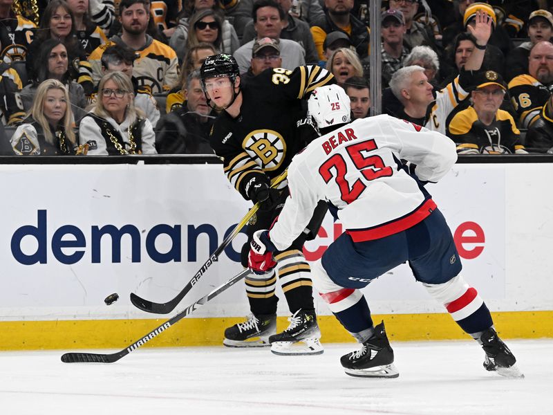 Feb 10, 2024; Boston, Massachusetts, USA; Boston Bruins center Morgan Geekie (39) passes the puck in front of Washington Capitals defenseman Ethan Bear (25) during the first period at the TD Garden. Mandatory Credit: Brian Fluharty-USA TODAY Sports