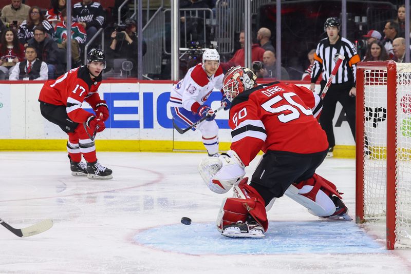 Jan 17, 2024; Newark, New Jersey, USA; New Jersey Devils goaltender Nico Daws (50) makes a save against the Montreal Canadiens during the first period at Prudential Center. Mandatory Credit: Ed Mulholland-USA TODAY Sports