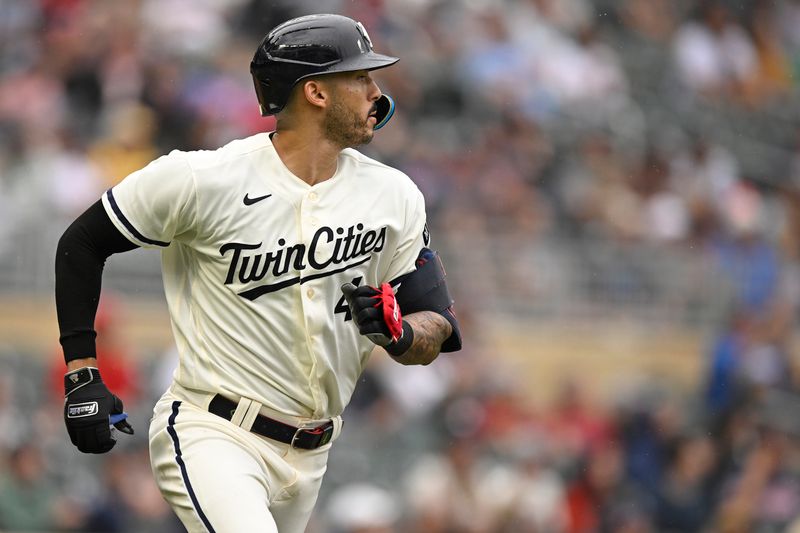 Aug 6, 2023; Minneapolis, Minnesota, USA;  Minnesota Twins infielder Carlos Correa (4) heads to first on a single in which he collected his 600th and 601st career RBI against the Arizona Diamondbacks during the sixth inning at Target Field. Mandatory Credit: Nick Wosika-USA TODAY Sports