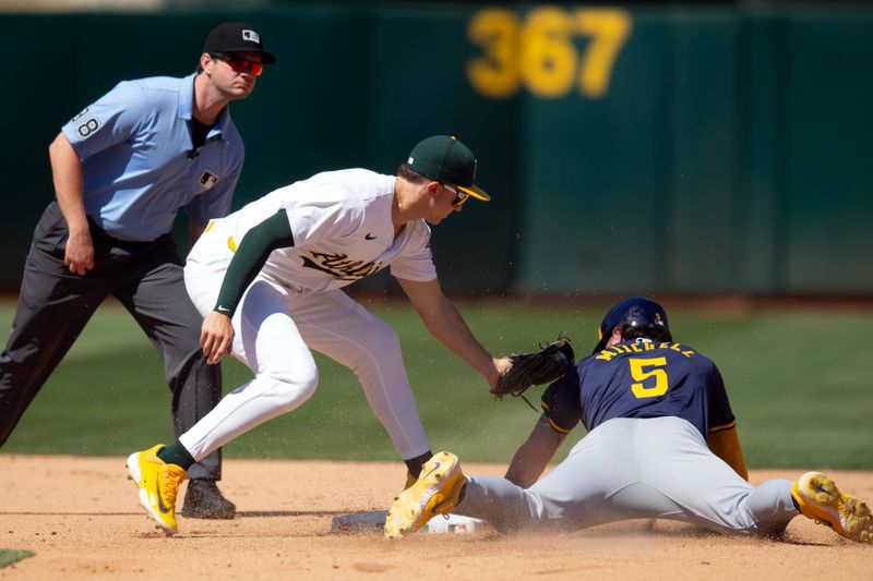 Aug 25, 2024; Oakland, California, USA; Oakland Athletics second baseman Zack Gelof (20) applies the tag in time to put out Milwaukee Brewers pinch runner Garrett Mitchell (5) during the seventh inning at Oakland-Alameda County Coliseum. Mandatory Credit: D. Ross Cameron-USA TODAY Sports