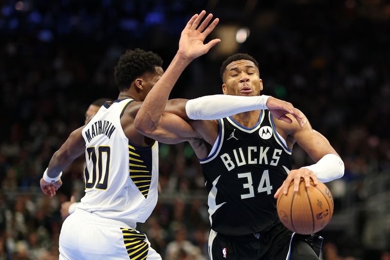 MILWAUKEE, WISCONSIN - NOVEMBER 22: Giannis Antetokounmpo #34 of the Milwaukee Bucks is fouled by Bennedict Mathurin #00 of the Indiana Pacers during the second half of a game in the NBA Emirates Cup at Fiserv Forum on November 22, 2024 in Milwaukee, Wisconsin. NOTE TO USER: User expressly acknowledges and agrees that, by downloading and or using this photograph, User is consenting to the terms and conditions of the Getty Images License Agreement. (Photo by Stacy Revere/Getty Images)