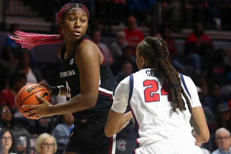 Feb 19, 2023; Oxford, Mississippi, USA; South Carolina Gamecocks forward Aliyah Boston (4) spins toward the basket as Mississippi Rebels forward Madison Scott (24) defends during the first half at The Sandy and John Black Pavilion at Ole Miss. Mandatory Credit: Petre Thomas-USA TODAY Sports