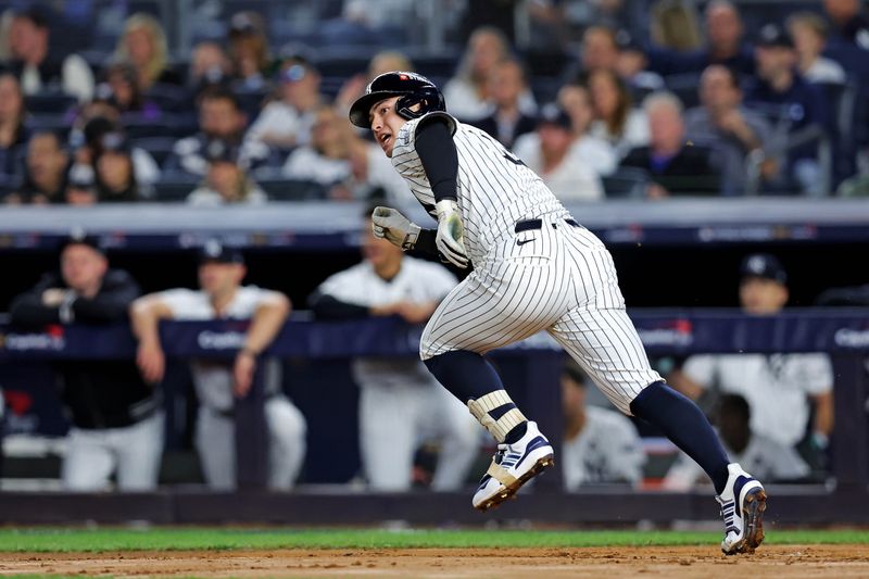 Oct 30, 2024; New York, New York, USA; New York Yankees shortstop Anthony Volpe (11) hits a double during the second inning against the Los Angeles Dodgers in game four of the 2024 MLB World Series at Yankee Stadium. Mandatory Credit: Brad Penner-Imagn Images