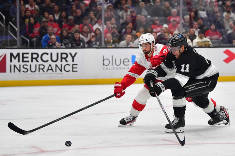 Oct 30, 2025; Los Angeles, California, USA; Detroit Red Wings center Dylan Larkin (71) plays for the puck against Los Angeles Kings center Anze Kopitar (11) during the second period at Crypto.com Arena. Mandatory Credit: Gary A. Vasquez-Imagn Images