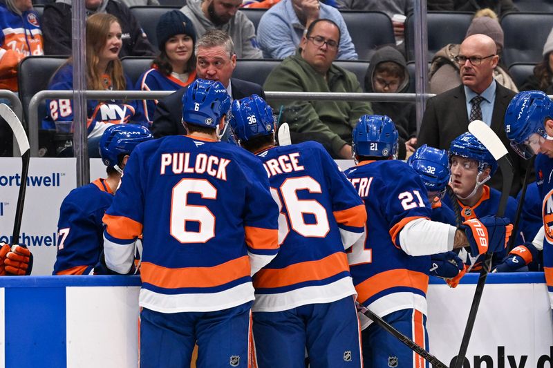 Nov 27, 2024; Elmont, New York, USA;  New York Islanders head coach Patrick Roy talks to the New York Islanders during a timeout against the Boston Bruins during the first period at UBS Arena. Mandatory Credit: Dennis Schneidler-Imagn Images