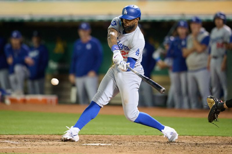 Aug 3, 2024; Oakland, California, USA; Los Angeles Dodgers outfielder Jason Heyward (23) hits an RBI single against the Oakland Athletics during the ninth inning at Oakland-Alameda County Coliseum. Mandatory Credit: Robert Edwards-USA TODAY Sports