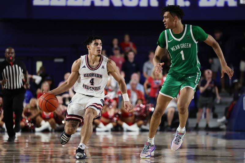 Jan 28, 2024; Boca Raton, Florida, USA; Florida Atlantic Owls guard Bryan Greenlee (4) dribbles the basketball as North Texas Mean Green forward Aaron Scott (1) defends during the second half at Eleanor R. Baldwin Arena. Mandatory Credit: Sam Navarro-USA TODAY Sports