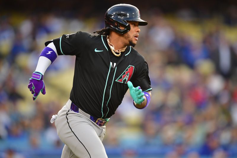 May 22, 2024; Los Angeles, California, USA; Arizona Diamondbacks second baseman Ketel Marte (4) runs after hitting a single against the Los Angeles Dodgers during the first inning at Dodger Stadium. Mandatory Credit: Gary A. Vasquez-USA TODAY Sports