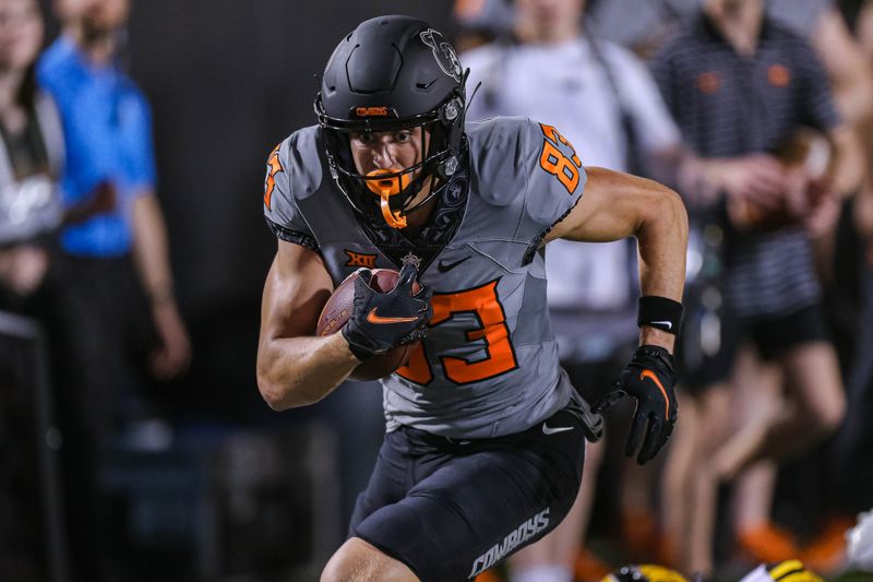 Sep 17, 2022; Stillwater, Oklahoma, USA; Oklahoma State Cowboys wide receiver Cale Cabbiness (83) runs for a touchdown against the Arkansas-Pine Bluff Golden Lions during the fourth quarter at Boone Pickens Stadium. OSU won 63-7. Mandatory Credit: Nathan J. Fish-USA TODAY Sports