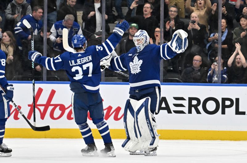 Mar 2, 2024; Toronto, Ontario, CAN;  Toronto Maple Leafs goalie Ilya Samsonov (35) and defenseman Timothy Liljegren (37) celebrate after an overtime shootout win over the New York Rangers at Scotiabank Arena. Mandatory Credit: Dan Hamilton-USA TODAY Sports