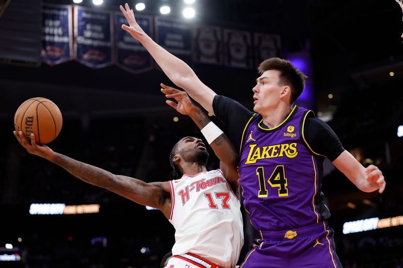 HOUSTON, TEXAS - NOVEMBER 08: Tari Eason #17 of the Houston Rockets drives against Colin Castleton #14 of the Los Angeles Lakers during the second half at Toyota Center on November 08, 2023 in Houston, Texas. NOTE TO USER: User expressly acknowledges and agrees that, by downloading and or using this photograph, User is consenting to the terms and conditions of the Getty Images License Agreement.? (Photo by Carmen Mandato/Getty Images)