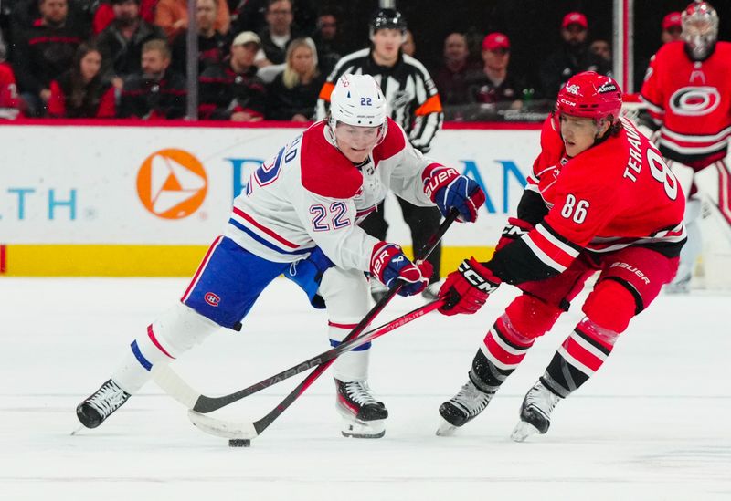 Dec 28, 2023; Raleigh, North Carolina, USA; Carolina Hurricanes left wing Teuvo Teravainen (86) and Montreal Canadiens right wing Cole Caufield (22) battle over the puck during the first period at PNC Arena. Mandatory Credit: James Guillory-USA TODAY Sports