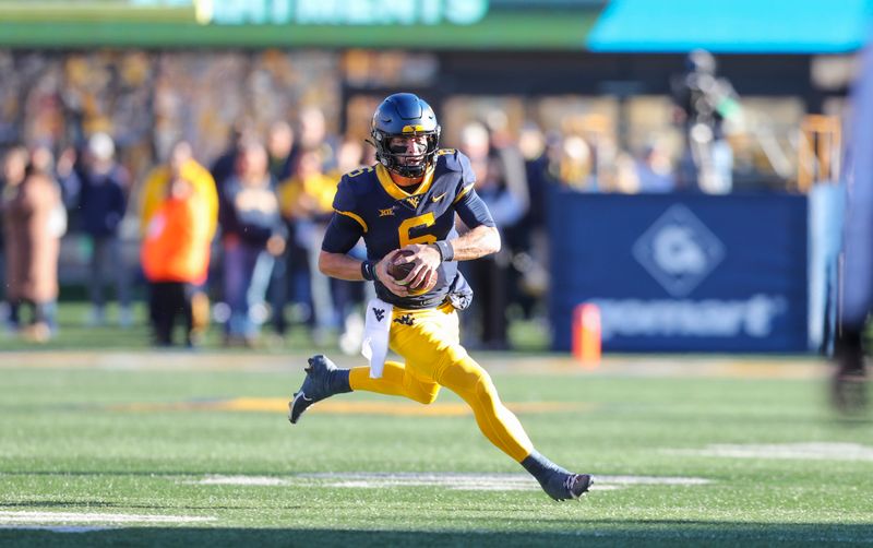 Nov 18, 2023; Morgantown, West Virginia, USA; West Virginia Mountaineers quarterback Garrett Greene (6) runs for extra yards during the first quarter against the Cincinnati Bearcats at Mountaineer Field at Milan Puskar Stadium. Mandatory Credit: Ben Queen-USA TODAY Sports