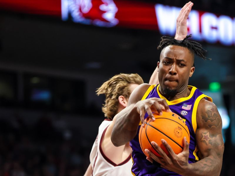 Feb 17, 2024; Columbia, South Carolina, USA; LSU Tigers guard Trae Hannibal (0) grabs a rebound against the South Carolina Gamecocks in the first half at Colonial Life Arena. Mandatory Credit: Jeff Blake-USA TODAY Sports