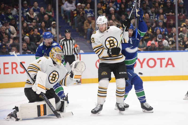 Feb 24, 2024; Vancouver, British Columbia, CAN;  Boston Bruins goaltender Jeremy Swayman (1) and defenseman Parker Wotherspoon (29) defend against Vancouver Canucks forward Pius Suter (24) during the first period at Rogers Arena. Mandatory Credit: Anne-Marie Sorvin-USA TODAY Sports