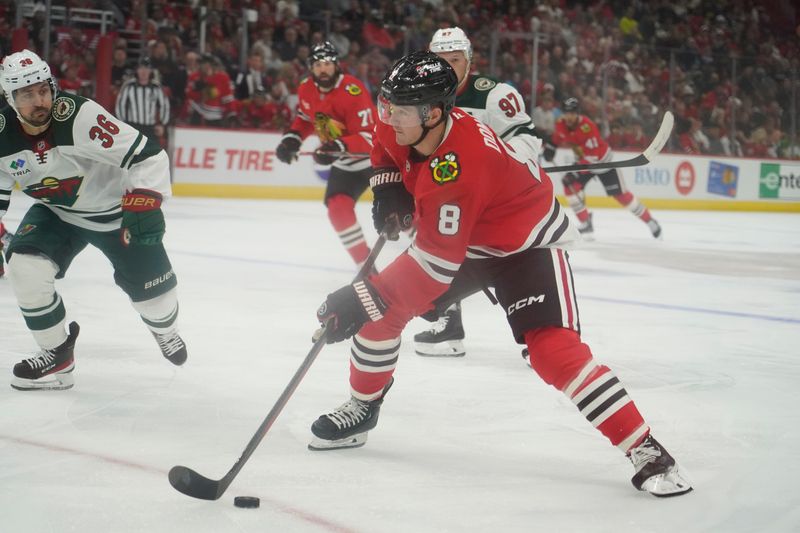 Oct 4, 2024; Chicago, Illinois, USA; Chicago Blackhawks center Ryan Donato (8) is defended by Minnesota Wild right wing Mats Zuccarello (36) during the first period at United Center. Mandatory Credit: David Banks-Imagn Images