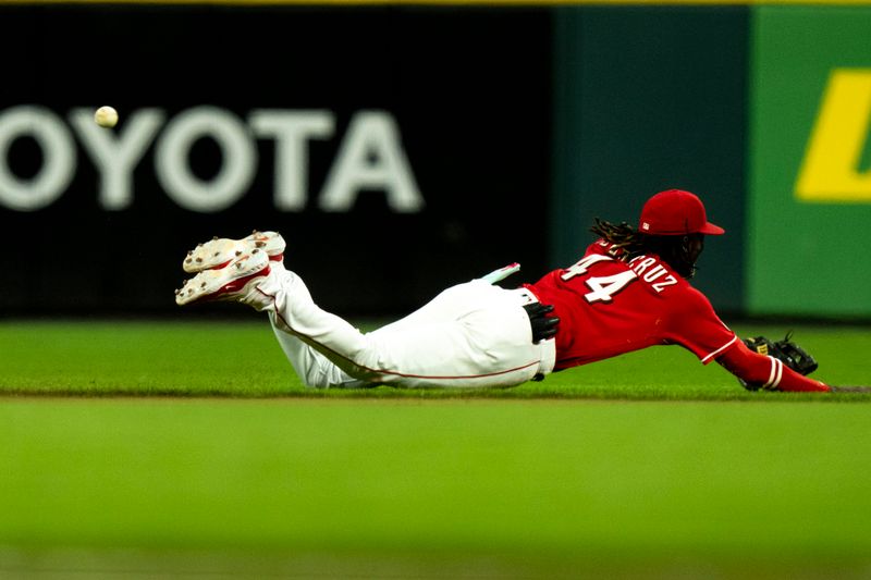 Sep 23, 2023; Cincinnati, Ohio, USA; Cincinnati Reds shortstop Elly De La Cruz (44) dives for a ground ball in the fifth inning against the Pittsburgh Pirates at Great American Ball Park. Mandatory Credit: The Cincinnati Enquirer-USA TODAY Sports