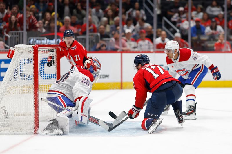 Oct 31, 2024; Washington, District of Columbia, USA; Washington Capitals center Aliaksei Protas (21) scores a goal on Montreal Canadiens goaltender Cayden Primeau (30) in the third period at Capital One Arena. Mandatory Credit: Geoff Burke-Imagn Images