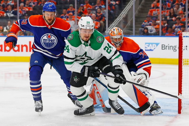 May 27, 2024; Edmonton, Alberta, CAN;   Dallas Stars forward Roope Hintz (24) and Edmonton Oilers defensemen Vincent Desharnais (73) chase a loose puck during the second period in game three of the Western Conference Final of the 2024 Stanley Cup Playoffs at Rogers Place. Mandatory Credit: Perry Nelson-USA TODAY Sports