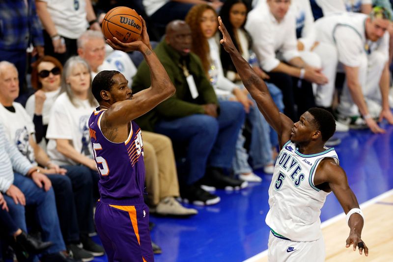 MINNEAPOLIS, MINNESOTA - APRIL 23: Kevin Durant #35 of the Phoenix Suns shoots against Anthony Edwards #5 of the Minnesota Timberwolves in the third quarter of game two of the Western Conference First Round Playoffs at Target Center on April 23, 2024 in Minneapolis, Minnesota. The Timberwolves defeated the Sun 105-93. NOTE TO USER: User expressly acknowledges and agrees that, by downloading and or using this photograph, User is consenting to the terms and conditions of the Getty Images License Agreement. (Photo by David Berding/Getty Images)