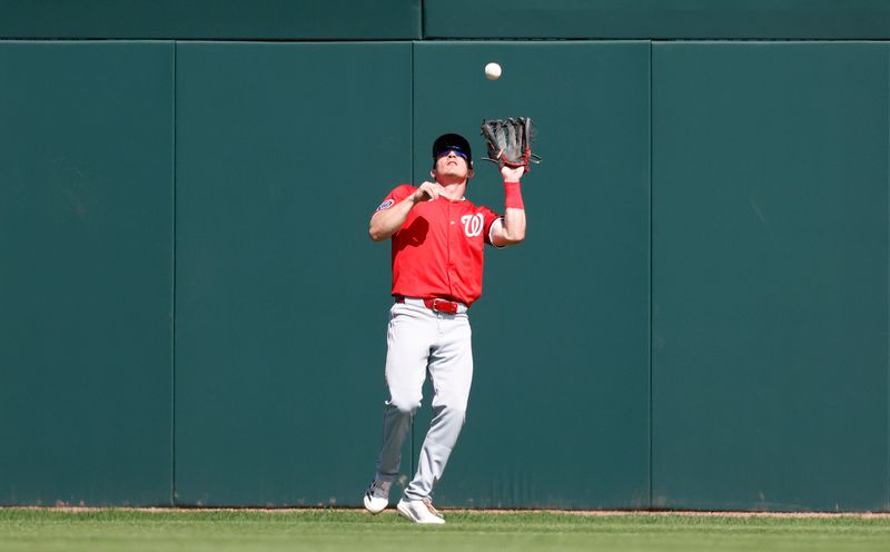 Feb 25, 2025; Jupiter, Florida, USA;  Washington Nationals center fielder Jacob Young (30) catches a fly ball to retire Miami Marlins right fielder Griffin Conine (not pictured) during the second inning at Roger Dean Chevrolet Stadium. Mandatory Credit: Rhona Wise-Imagn Image 