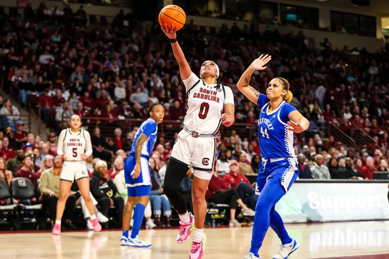 Jan 15, 2024; Columbia, South Carolina, USA; South Carolina Gamecocks guard Te-Hina Paopao (0) drives past Kentucky Wildcats forward Janae Walker (44) in the first half at Colonial Life Arena. Mandatory Credit: Jeff Blake-USA TODAY Sports