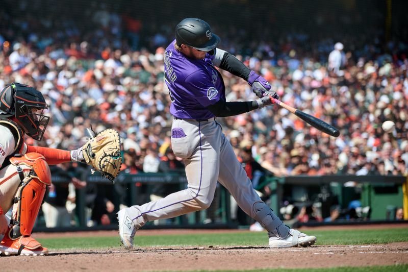 May 4, 2025; San Francisco, California, USA; Colorado Rockies catcher Hunter Goodman (15) hits an RBI single against the San Francisco Giants during the eighth inning at Oracle Park. Mandatory Credit: Robert Edwards-Imagn Images