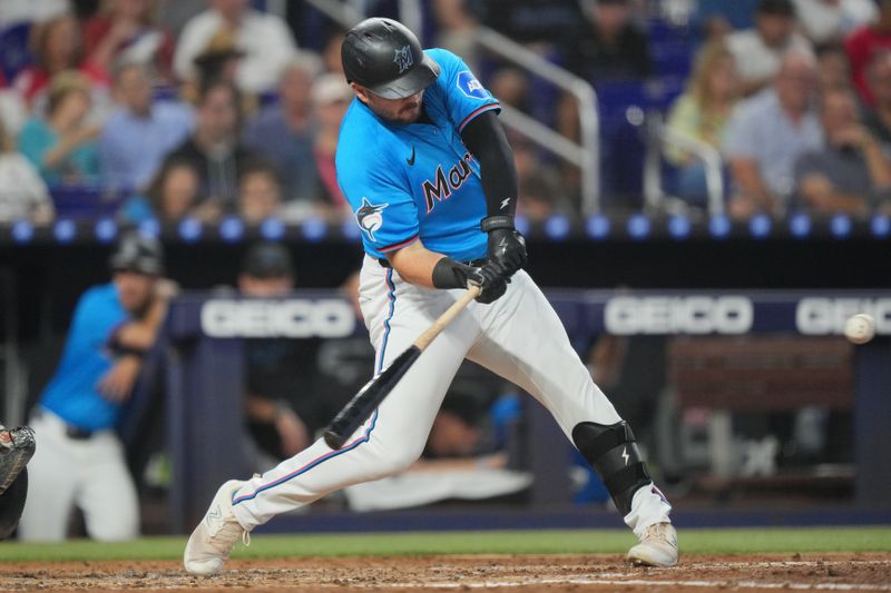 Sep 22, 2024; Miami, Florida, USA;  Miami Marlins designated hitter Jake Burger (36) hits a home run in the fourth inning against the Atlanta Braves at loanDepot Park. Mandatory Credit: Jim Rassol-Imagn Images