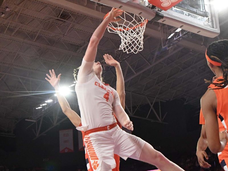 Feb 22, 2023; Clemson, South Carolina, USA; Clemson forward Ian Schieffelin (4) shoots the ball against center Jesse Edwards (14) during the second half at Littlejohn Coliseum. Mandatory Credit: Ken Ruinard-USA TODAY Sports