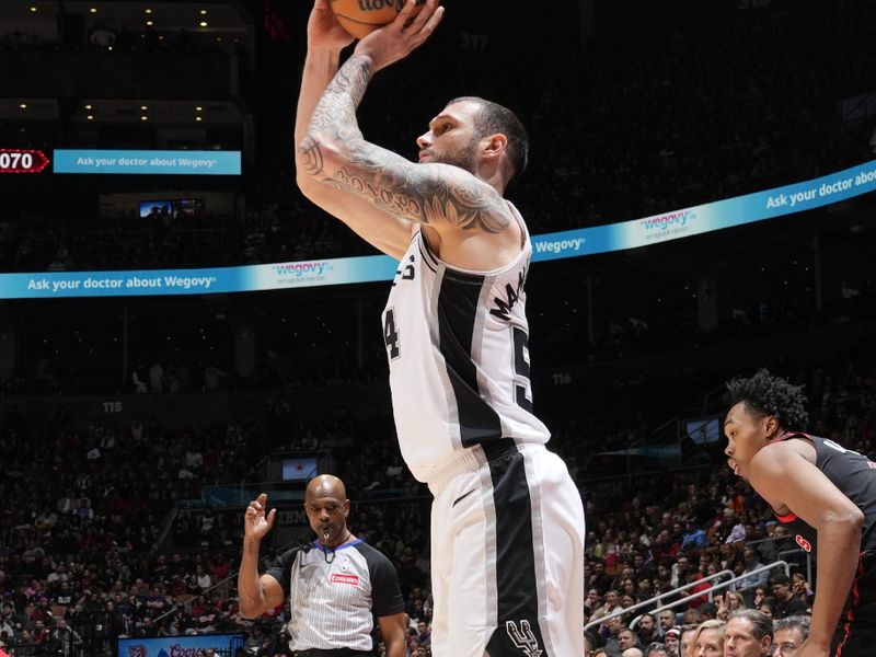 TORONTO, CANADA - MARCH 23: Sandro Mamukelashvili #54 of the San Antonio Spurs shoots a three point basket during the game against the Toronto Raptors  on March 23, 2025 at the Scotiabank Arena in Toronto, Ontario, Canada.  NOTE TO USER: User expressly acknowledges and agrees that, by downloading and or using this Photograph, user is consenting to the terms and conditions of the Getty Images License Agreement.  Mandatory Copyright Notice: Copyright 2025 NBAE (Photo by Mark Blinch/NBAE via Getty Images)