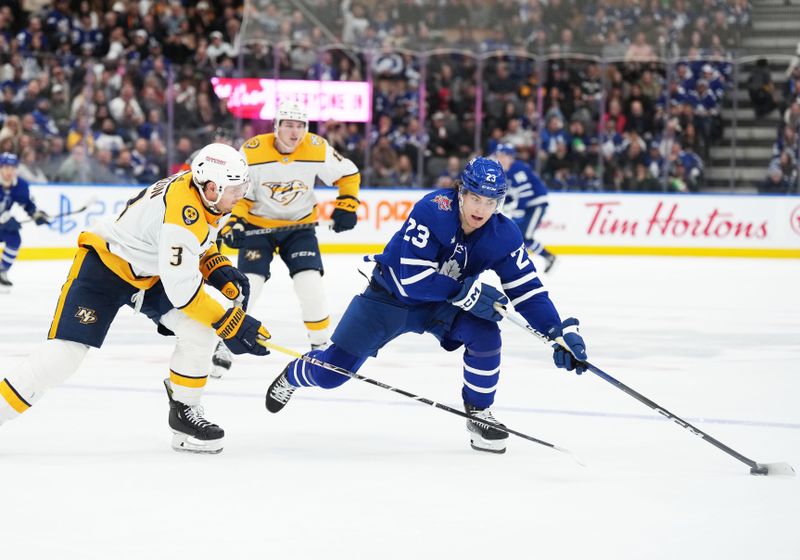 Dec 9, 2023; Toronto, Ontario, CAN; Toronto Maple Leafs left wing Matthew Knies (23) skates with the puck as Nashville Predators defenseman Jeremy Lauzon (3) gives chase during the third period at Scotiabank Arena. Mandatory Credit: Nick Turchiaro-USA TODAY Sports