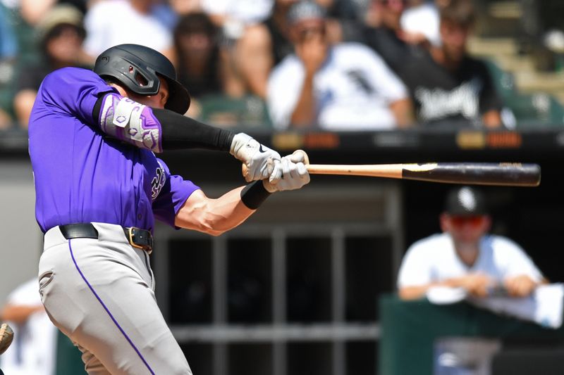 Jun 29, 2024; Chicago, Illinois, USA; Colorado Rockies left fielder Nolan Jones (22) hits a two-run home run during the fifth inning against the Chicago White Sox at Guaranteed Rate Field. Mandatory Credit: Patrick Gorski-USA TODAY Sports