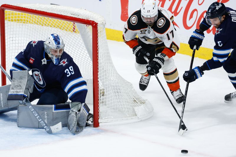 Mar 15, 2024; Winnipeg, Manitoba, CAN; Anaheim Ducks forward Alex Killorn (17) attempts a wrap around against Winnipeg Jets goalie Laurent Boissoit (39) during the third period at Canada Life Centre. Mandatory Credit: Terrence Lee-USA TODAY Sports